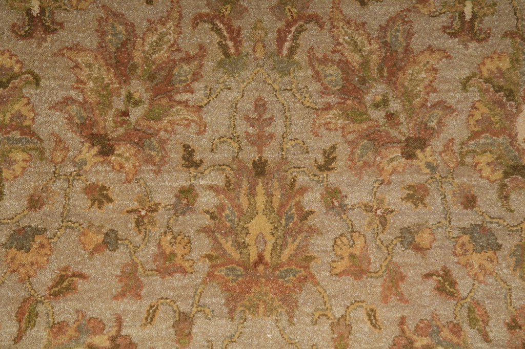Close-up of a patterned carpet with intricate designs in earthy tones.