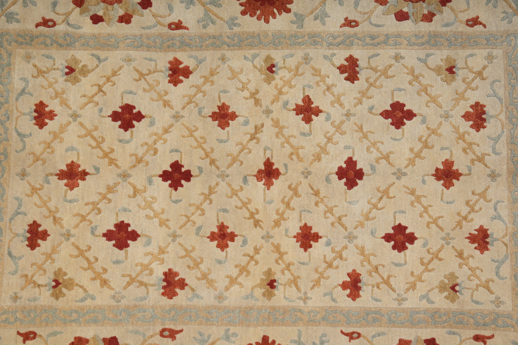 Decorative rug with geometric pattern and red floral elements on beige background