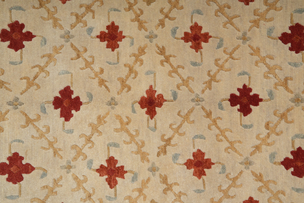 Patterned fabric with red floral designs on a beige background