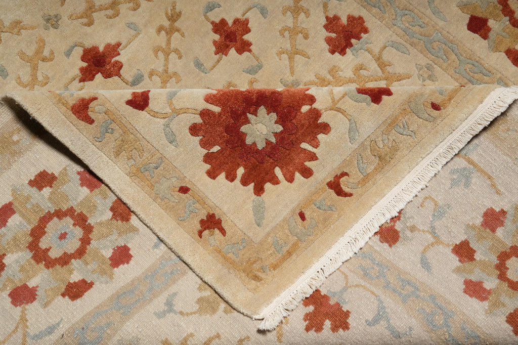 Close-up of a patterned rug with red and beige colors