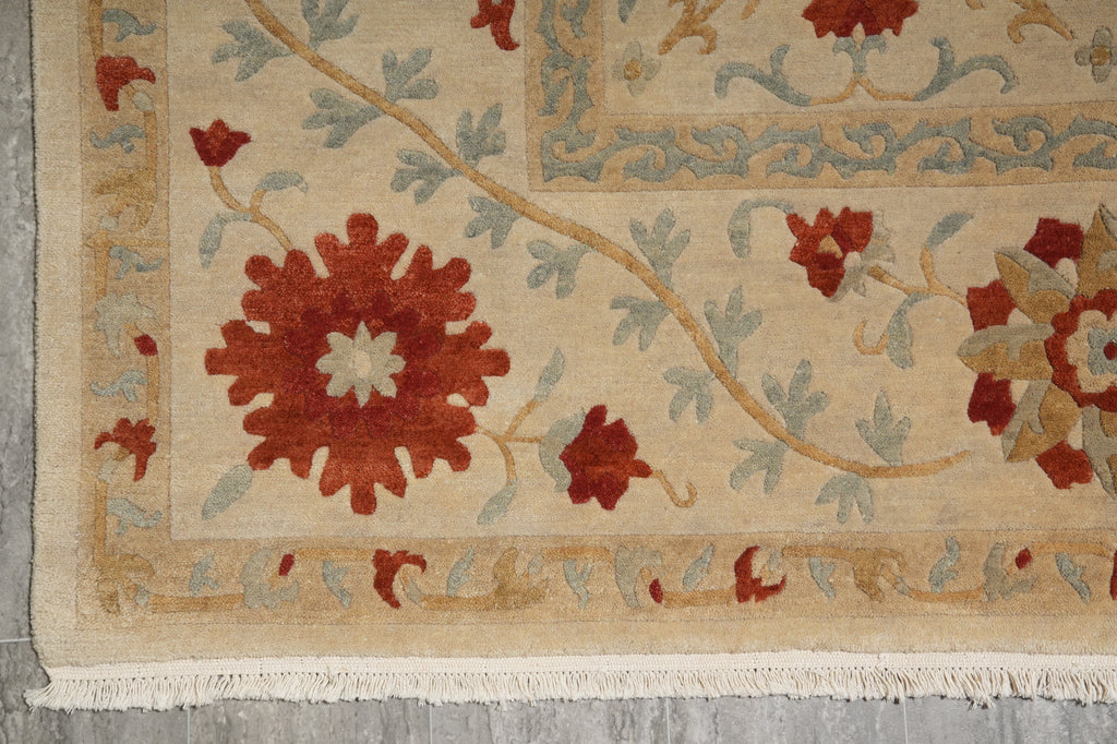 Close-up of an intricately designed rug with floral patterns on a neutral background