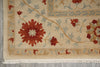 Load image into Gallery viewer, Close-up of an intricately designed rug with floral patterns on a neutral background