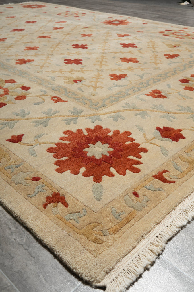 Close-up of a patterned rug with geometric design on a gray floor.