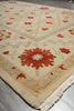 Load image into Gallery viewer, Close-up of a patterned rug with geometric design on a gray floor.