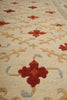 Load image into Gallery viewer, Close-up of a patterned rug with red and beige designs