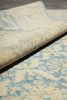 Load image into Gallery viewer, Close-up of a patterned rug with blue and beige colors on a wooden floor.
