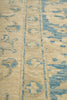 Load image into Gallery viewer, Close-up of a textured fabric with blue patterns on a beige background