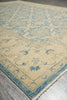 Load image into Gallery viewer, Beige and blue patterned rug on a wooden floor