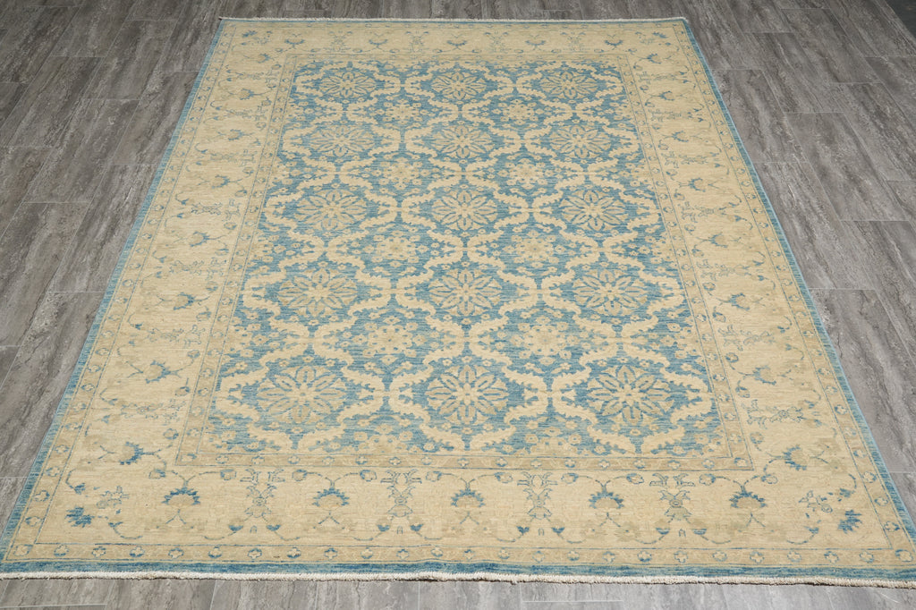 Beige and blue patterned rug on a wooden floor