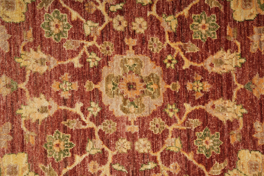 Close-up of a patterned red and gold rug
