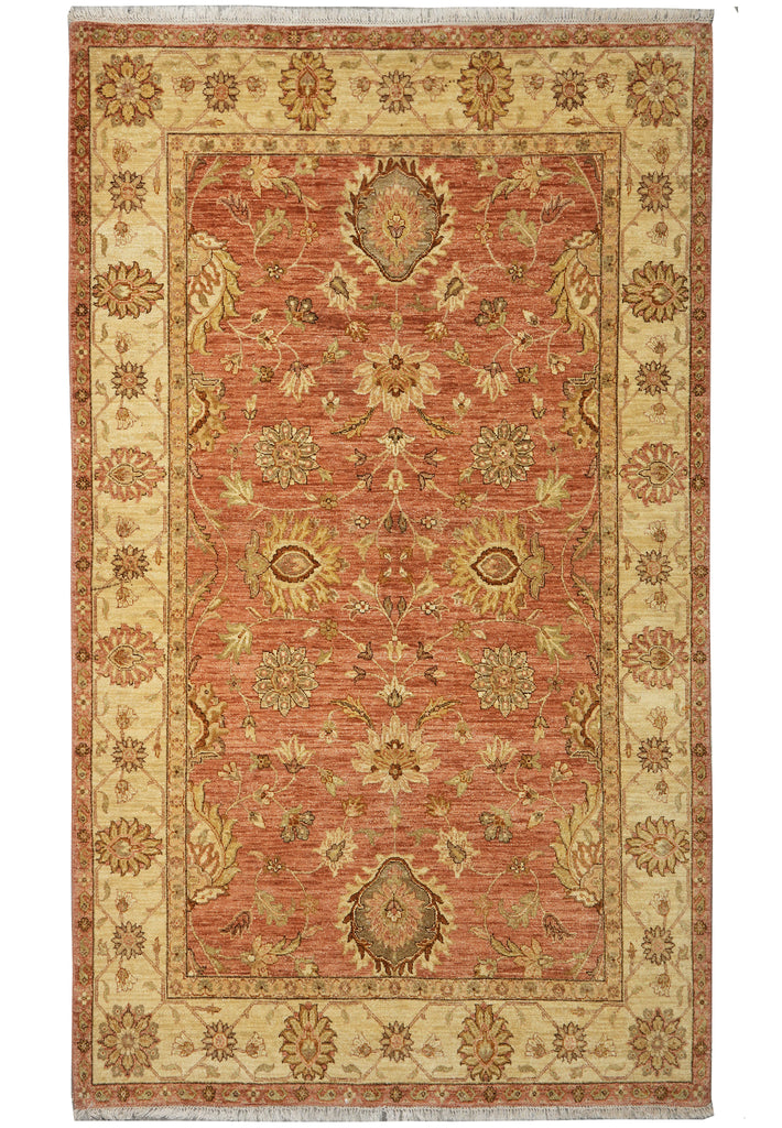 Decorative rug with intricate patterns on a red and beige background
