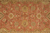 Load image into Gallery viewer, Close-up of a patterned rug with floral and geometric designs on a red-brown background.