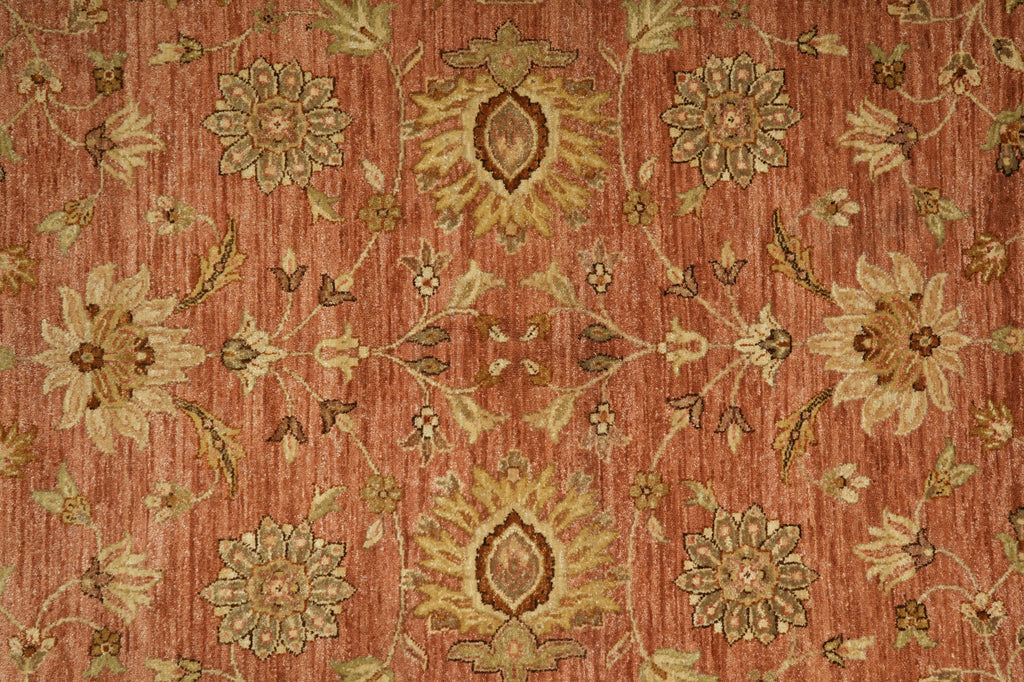 Close-up of a patterned rug with floral designs on a red-brown background