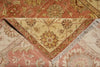Load image into Gallery viewer, Close-up of a patterned rug with floral designs and fringed edges.