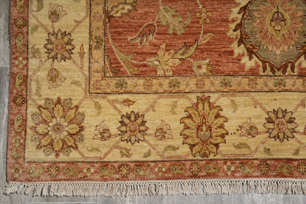 Close-up of a patterned rug with floral designs on a neutral background