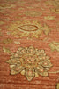Load image into Gallery viewer, Close-up of a patterned rug with intricate designs on a red-brown background