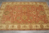 Load image into Gallery viewer, Decorative red and beige patterned rug on a wooden floor
