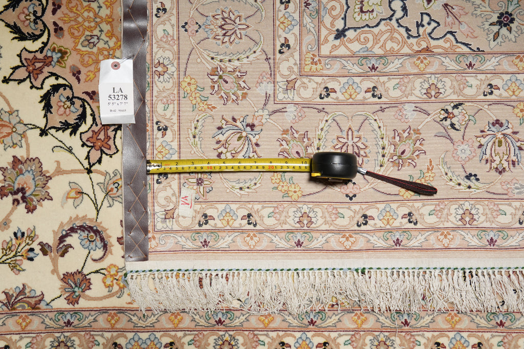 Decorative rug with a measuring tape and price tag on a wooden floor.