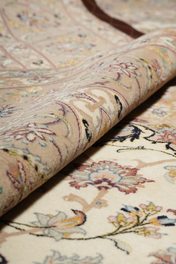 Close-up of a rolled-up floral-patterned rug with intricate details.