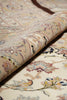 Load image into Gallery viewer, Close-up of a rolled-up floral-patterned rug with intricate details.