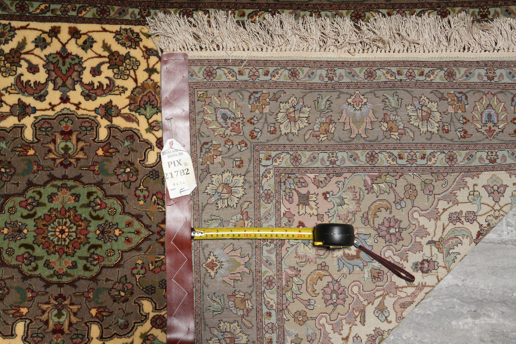 Decorative rug with a measuring tape on top, showing measurements.