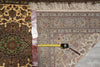 Load image into Gallery viewer, Decorative rug with a measuring tape on top, showing measurements.