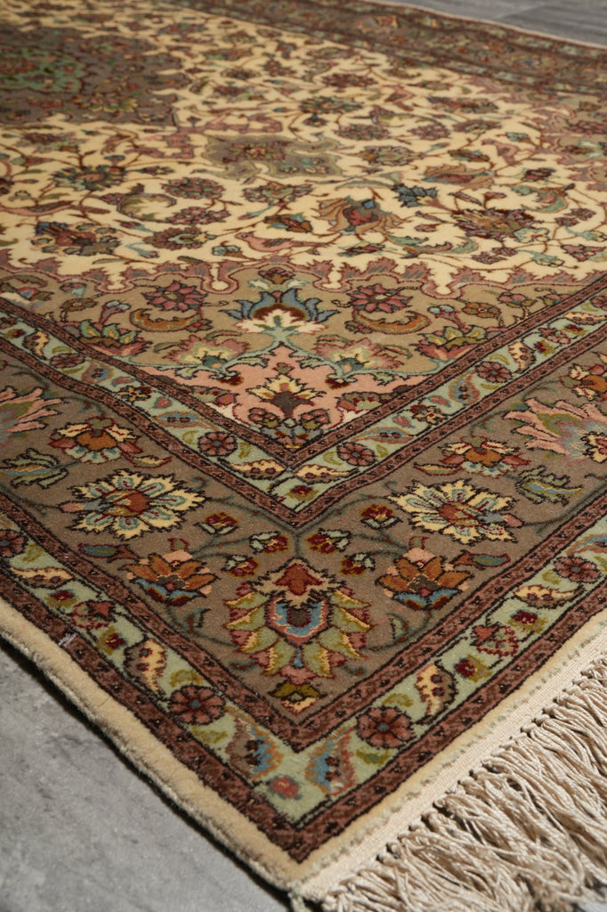 Close-up of a patterned rug with fringes on a neutral background