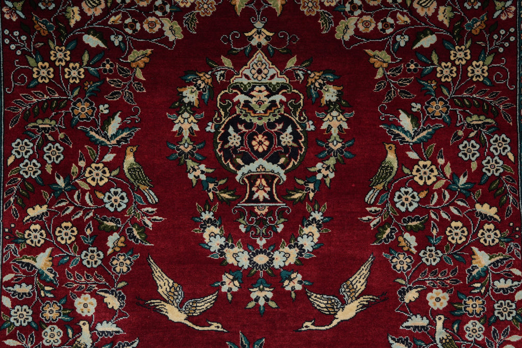 Decorative rug with intricate patterns on a red background