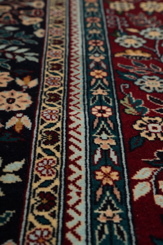 Close-up of a patterned fabric with floral and geometric designs.