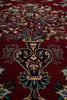 Load image into Gallery viewer, Close-up of a patterned rug with intricate designs on a red background