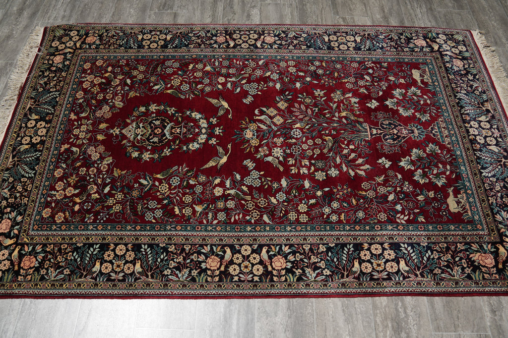 Decorative rug with intricate patterns on a wooden floor