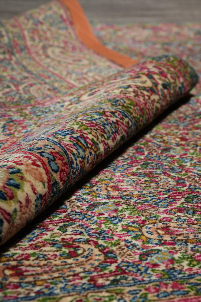 Close-up of a multicolored patterned rug with vibrant colors.