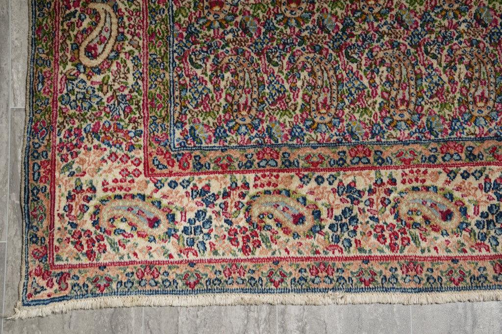 Decorative rug with intricate patterns on a gray floor