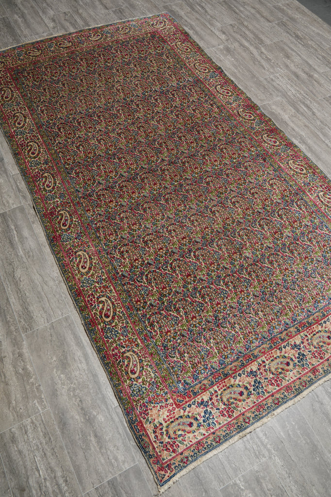 Decorative rug with intricate patterns on a wooden floor