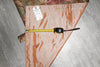 Load image into Gallery viewer, Measuring tape on a pink fabric with a label, on a tiled floor.