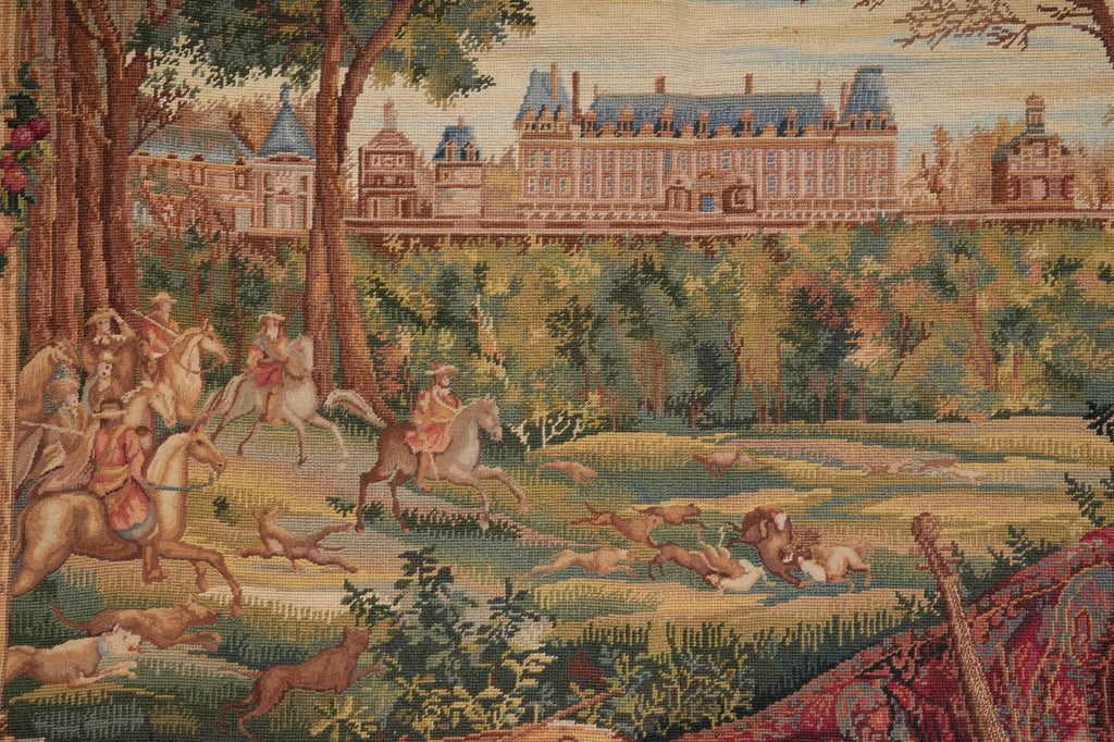 Tapestry depicting a pastoral scene with people on horseback and a large building in the background.
