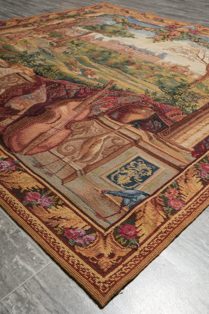 Decorative tapestry with a classical scene on a wooden floor.