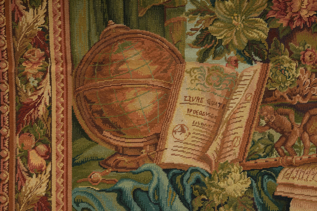 Tapestry with a detailed design including a globe and open book, surrounded by floral elements.