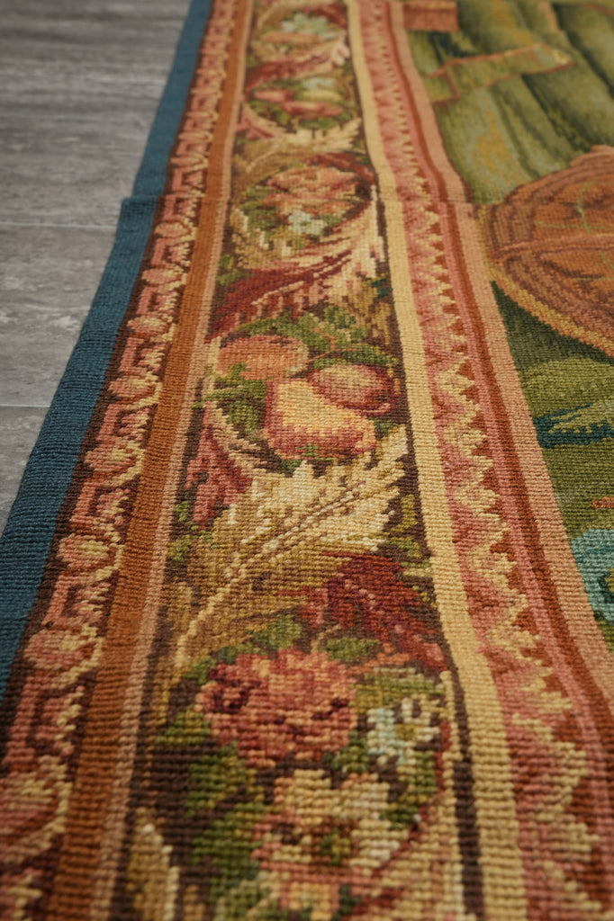 Close-up of a detailed tapestry with floral patterns and intricate designs.