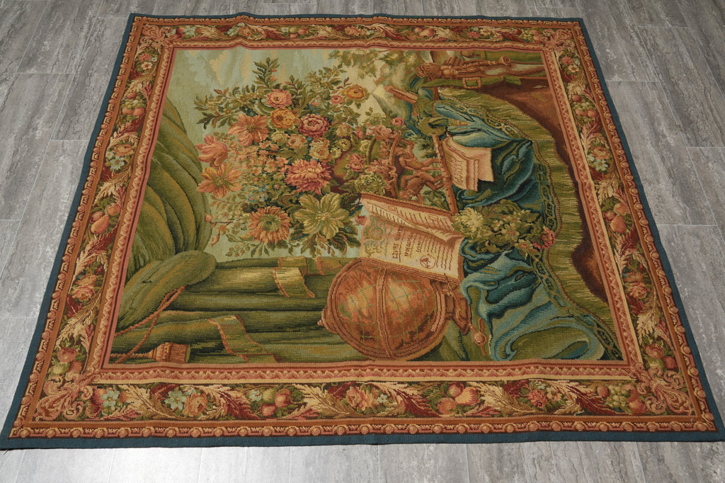 Decorative rug with floral design and books on a wooden floor