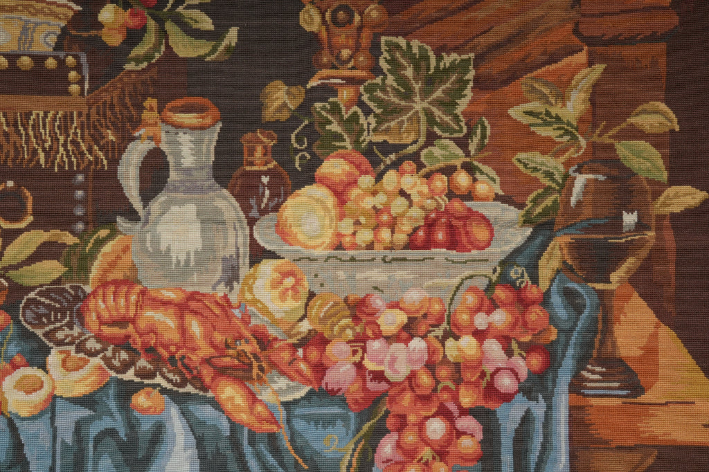 Decorative tapestry with a still life scene of fruits, flowers, and kitchen items.