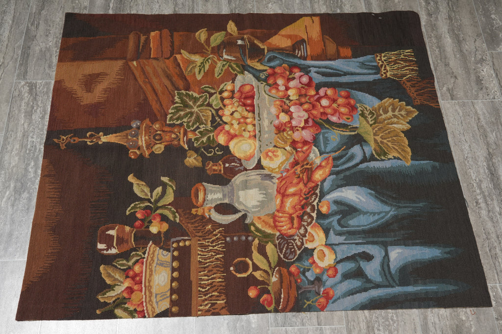 Decorative rug with a still life design featuring fruits and a vase on a wooden floor.