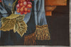 Load image into Gallery viewer, Close-up of a detailed tapestry with a person holding grapes and leaves.
