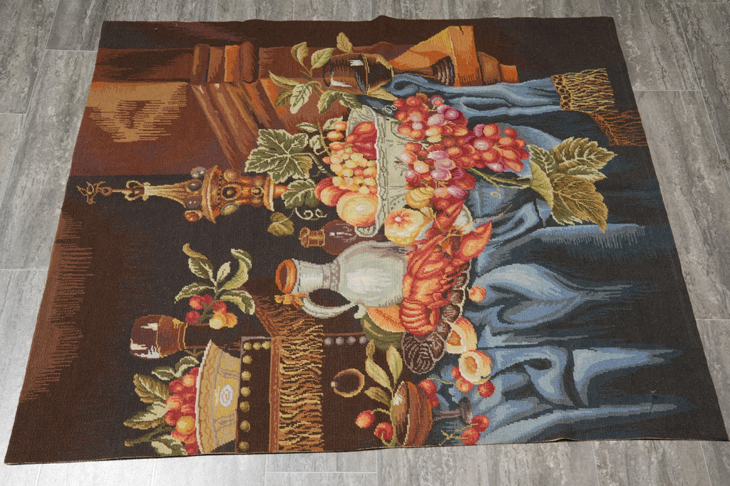 Decorative rug with a still life design featuring fruits, flowers, and a vase on a wooden surface.