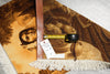 Load image into Gallery viewer, Decorative rug with artistic design and measuring tape on a textured surface