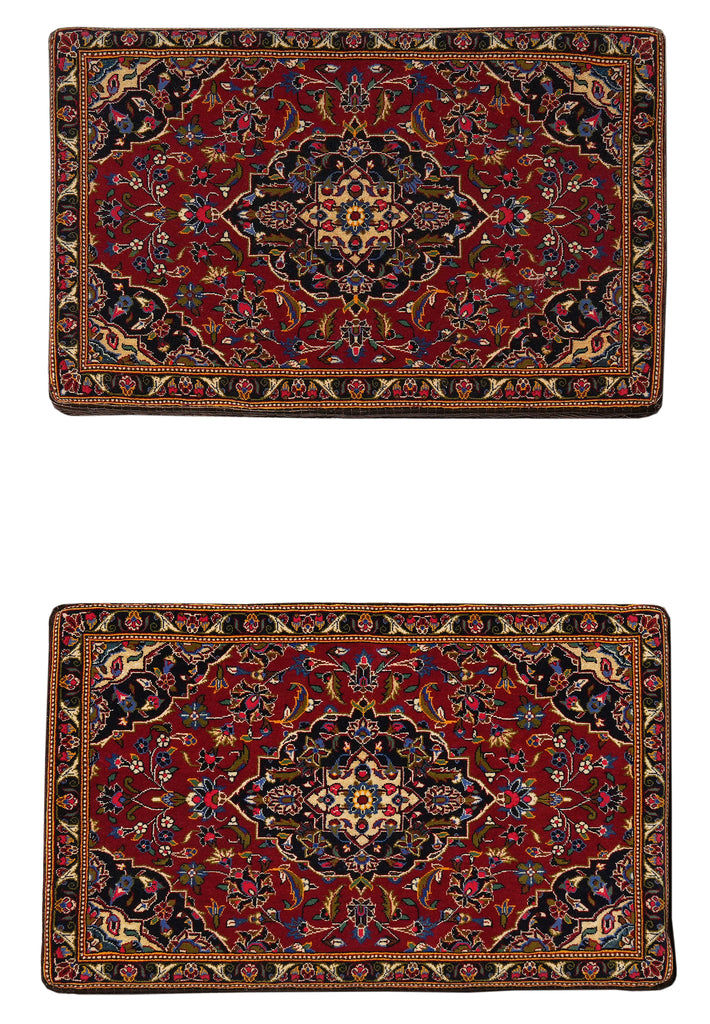 Two ornate red rugs with intricate patterns on a white background
