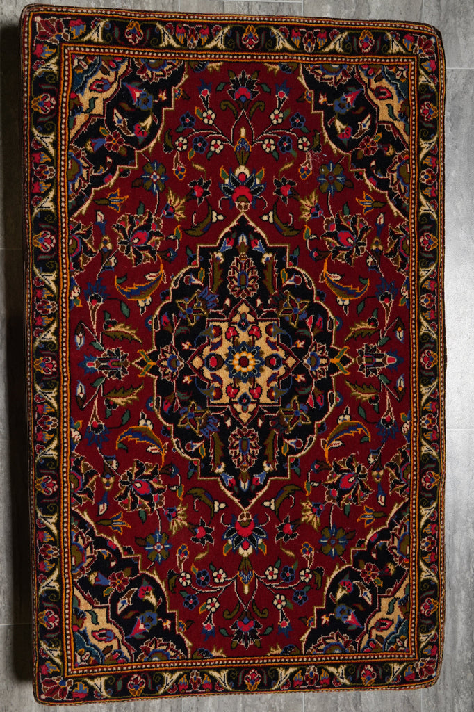 Decorative rug with intricate patterns on a wooden floor