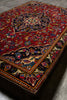 Load image into Gallery viewer, Close-up of a patterned rug with intricate designs on a gray surface
