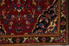 Load image into Gallery viewer, Close-up of a intricately designed rug with floral patterns on a red background.