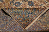 Load image into Gallery viewer, A folded traditional oriental rug with an intricate floral and vine pattern in beige, blue, brown, and rust tones, showing the corner design and fringed edge.